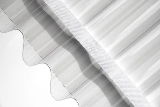 Elegant monochrome fabric overlay with soft shadows suitable for graphic design backgrounds, modern minimalist textile mockups.